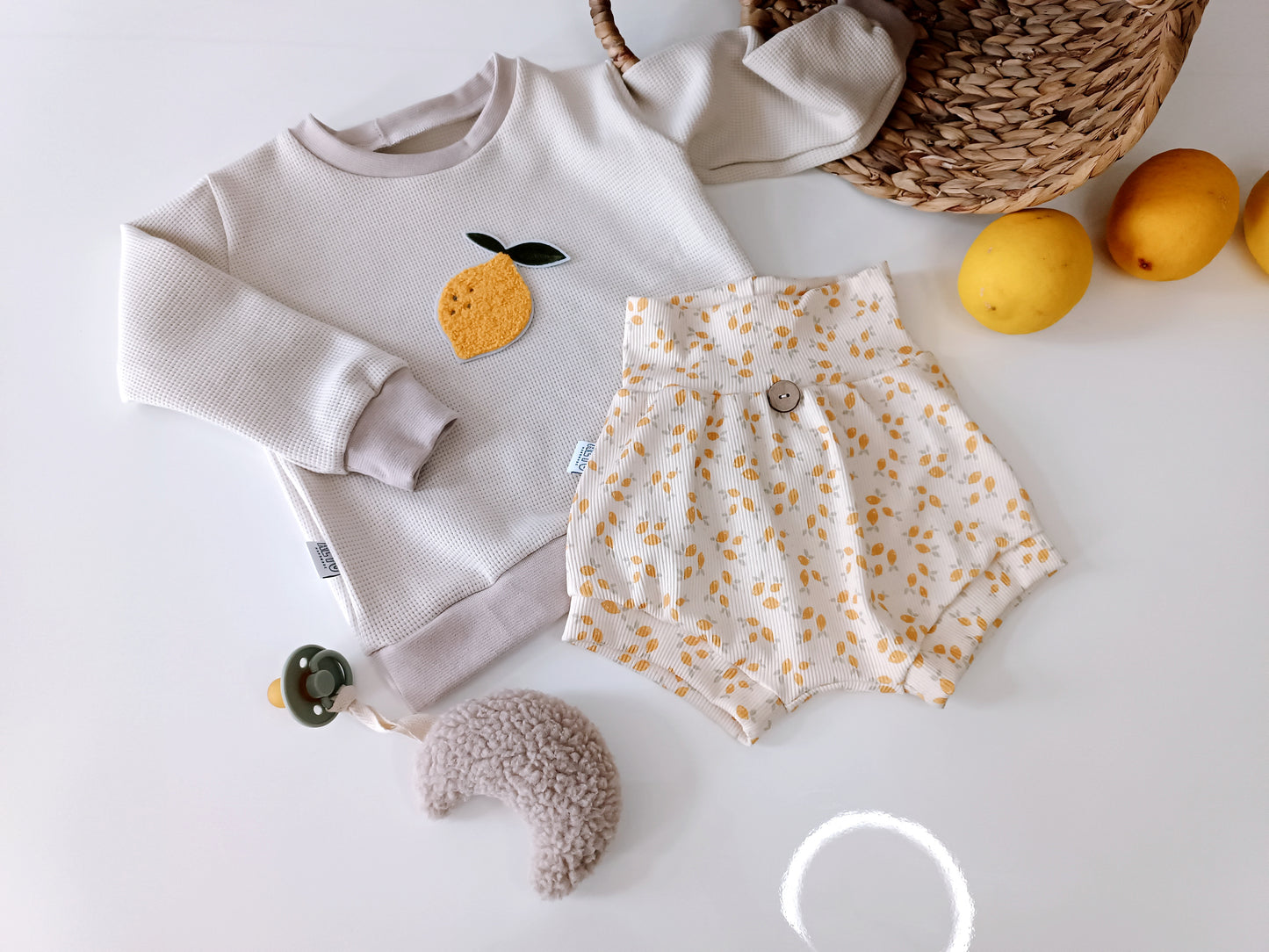 Baby sweater with lemon patch